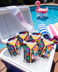 Esky of ice filled with MXTOLOGY Pornstar Martini cocktail pouches at a hens weekend pool party
