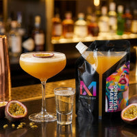 Pornstar Martini cocktail beside the MXTOLOGY pouch